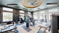 Located in Huntsville, Texas, this fitness center offers a thoughtfully designed exercise space spread across a single open floor. The room is generously proportioned, providing ample space for a comprehensive selection of both strength-training and cardiovascular equipment, including treadmills, ellipticals, stair climbers, rowing machines, cable machines, and a variety of resistance and free-weight stations from brands such as Matrix.

The interior design is energetic and purposeful. Bold motivational typography — featuring words like "Stamina," "Endurance," "Dedication," and "Sweat Goals" — covers the feature walls, creating an immersive and inspiring atmosphere. A distinctive tray ceiling with a sage green finish frames a large ceiling fan centerpiece, lending architectural character to the space. Sleek linear pendant lighting complements the natural light that pours in through multiple large windows, offering views of the surrounding outdoor landscape.

The flooring features a clean, two-tone striped pattern in white and blue-gray, adding visual structure to the workout zones. Full-length mirrors along the walls enhance the sense of openness while serving a functional purpose. A private door and accessible entry points provide convenient access throughout. Overall, the space strikes a balance between high-function fitness infrastructure and a modern, motivating aesthetic.