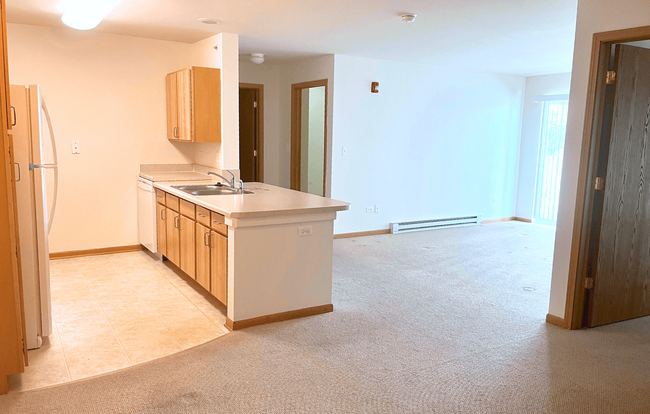 The bright open living space is perfect for entertaining. - St James Senior Apartments