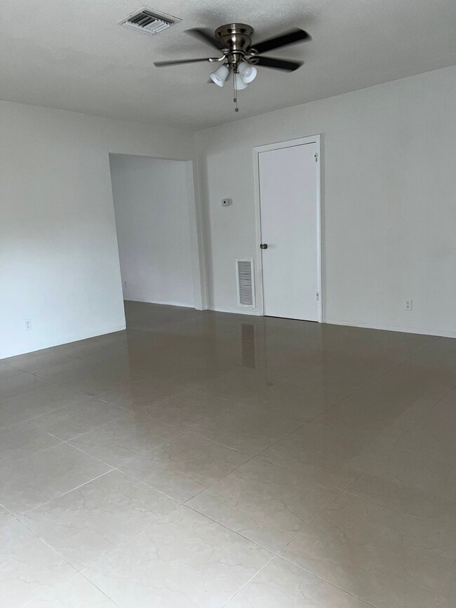 Living room: porcelain floors throughout. Ceiling fan in living room and two bedrooms - 5010 SW 26th Ave House