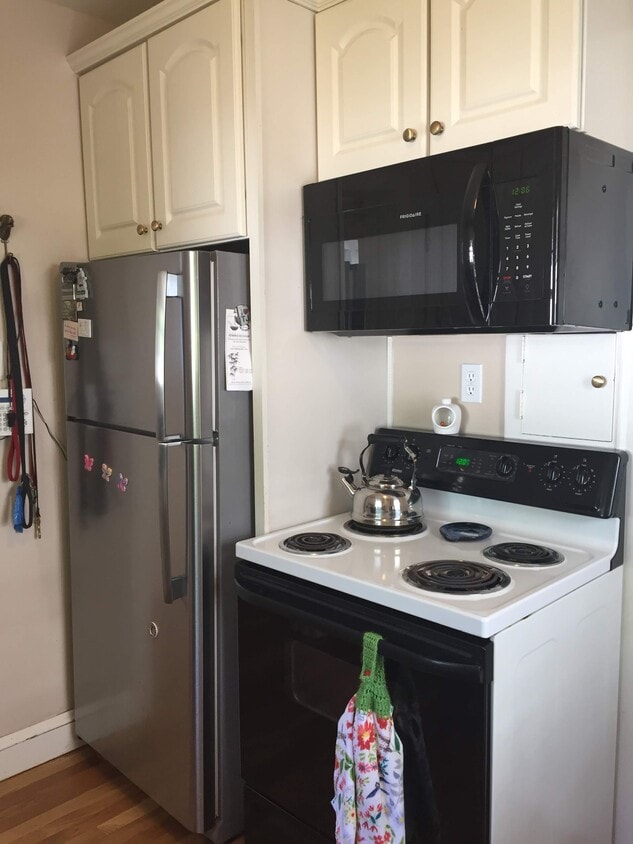 Kitchen with new fridge and microwave. - 1347 W Highland Pkwy