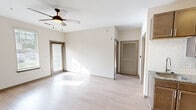 Located at 9635 Westland Cove Way in Knoxville, Tennessee, this thoughtfully designed one-bedroom, one-bathroom residence offers a comfortable and functional single-floor layout. The open living area features light wood-style flooring, neutral walls, and a ceiling fan that enhances airflow and comfort. Natural light streams in through blinded windows, creating a bright and welcoming atmosphere throughout the space. The kitchen is a standout feature, showcasing rich dark wood cabinetry, granite countertops, a classic subway tile backsplash, and a full suite of stainless steel appliances including a refrigerator, electric range, over-the-range microwave, and dishwasher. The bedroom is a well-sized retreat with plush carpeting, a ceiling fan, and a window overlooking greenery, complemented by a dedicated closet for storage. The bathroom includes a shower-tub combination with clean white tile surround and durable wood-look flooring. A dedicated laundry area with a full-size Whirlpool washer and dryer adds everyday convenience. Clean lines, a neutral color palette, and practical finishes throughout give this residence a move-in-ready appeal well-suited for comfortable living in the Knoxville area.