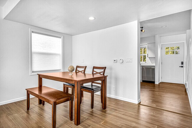 Living room and dining area with a view of the front door and kitchen - 3414 Wilson St