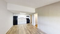 Located at 5161 Jaczko Ln in West Palm Beach, FL, this single-floor, one-bedroom, one-bathroom residence offers a practical and comfortable layout ideal for everyday living. The open-concept living and kitchen area is finished with light wood-look flooring, neutral-toned walls, and a textured ceiling, creating a bright and clean atmosphere. The kitchen features white cabinetry, a black refrigerator, a black electric range, and an under-cabinet range hood, all centered around a simple single-basin sink — offering a functional cooking space that flows seamlessly into the living area. Natural light enters through windows fitted with blinds, enhancing the airy feel of the main space. The bedroom is carpeted for comfort, includes a ceiling fan with light fixture, and is served by a window that brings in outdoor views and natural light. Three closets throughout the unit provide generous storage options. The full bathroom is clean and well-appointed, featuring a white vanity with shaker-style cabinetry, a tub-shower combo with a curtain rod, and consistent wood-look flooring. A dedicated utility room and hallway round out the thoughtful layout. This residence offers an efficient, move-in-ready living experience in a convenient West Palm Beach location.