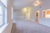 Located at 101 Little Bay Ave in Yorktown, Virginia, this single-floor residence offers a well-organized layout with a variety of functional living spaces. The centerpiece of the home is a generously sized living area distinguished by soaring vaulted ceilings and a ceiling fan, creating an airy, open atmosphere. Plush wall-to-wall carpeting runs throughout the living and bedroom areas, adding warmth underfoot, while wood-look flooring in the kitchen and bathrooms provides a practical, easy-to-maintain surface. The kitchen features light natural wood cabinetry, white countertops, a gas range, a built-in dishwasher, and a stainless steel sink — offering a clean and efficient workspace. Multiple bedrooms are finished with neutral gray walls, soft carpet, and windows fitted with horizontal blinds that allow for ample natural light and views of the surrounding neighborhood. One bedroom benefits from a direct en-suite bathroom connection. The bathrooms are outfitted with full tub-shower combinations, large mirrors, wood-tone vanities, and wood-look flooring, providing a clean and cohesive aesthetic throughout. The overall design of this residence emphasizes practicality and comfort, making it a well-rounded home in a residential Yorktown setting.