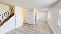 Located at 3779 Swiss Dr in Saint Louis, MO, this three-bedroom, two-bathroom home spans three floors, offering a well-organized and functional layout. Light wood-style flooring runs consistently throughout the space, complemented by crisp white walls and textured ceilings that give each room a clean, bright aesthetic.

The living room provides an open, airy feel with access to the staircase, which features a classic black metal railing with decorative scroll detailing. The kitchen is outfitted with white shaker-style cabinetry, stainless steel appliances including a range and full-size refrigerator, and ample counter space.

The three bedrooms are well-proportioned, each equipped with ceiling fans and natural light from large windows with horizontal blinds that frame neighborhood views. The spacious primary bedroom includes closet access and additional door configurations for added versatility. The secondary bedrooms offer similar finishes in a slightly more compact footprint.

Both bathrooms are finished in a clean, minimal style. One bathroom features a full tub-shower combo with white surround, a vanity with white cabinetry, and wood-style flooring. A utility room and hallway round out the floor plan. Staircases connect all three levels, making the home's vertical layout easy to navigate.