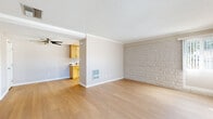Located at 9550 Fremont Ave in Montclair, CA, this two-bedroom, one-bathroom single-story home offers a well-organized layout across a comfortable floor plan. Light hardwood flooring flows consistently throughout, tying each room together with a clean, cohesive look.

The living room is an inviting open space highlighted by a distinctive textured brick accent wall, crown molding, and a textured ceiling. Natural light filters in through a window fitted with vertical blinds, and a wall-mounted heater provides functional comfort. An open sightline connects the living area directly to the kitchen, which features light wood cabinetry, white countertops, stainless steel appliances including an electric range, microwave, and dishwasher, and a window that brings in additional natural light.

The primary bedroom is generously sized, continuing the brick accent wall detail and natural light theme, and is equipped with a ceiling fan and access to a dedicated walk-in closet with built-in shelving. The second bedroom also features a ceiling fan, hardwood flooring, and its own closet with mirrored sliding doors.

The hallway connects all rooms efficiently and leads to the full bathroom, which is outfitted with a light wood vanity, white countertop, a large mirror, and a well-lit vanity fixture above. Throughout the home, neutral tones and consistent finishes create a calm, functional living environment.