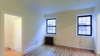 Located at 58 N Lansdowne Avenue in Lansdowne, Pennsylvania, this single-floor space offers a straightforward and functional layout with timeless interior details. The interior is finished with warm hardwood flooring throughout, lending a classic and inviting character to the space. Walls are painted in a soft, neutral tone that enhances the sense of brightness and openness, allowing natural light to play naturally across the room. Windows with traditional multi-pane grilles admit generous daylight and provide a connection to the outside. A classic cast-iron radiator beneath the window speaks to the building's heritage while providing reliable, efficient heating. Clean white baseboards and trim throughout add a crisp, polished contrast to the wood floors. The overall ambiance is calm and understated, offering a blank canvas well-suited to a variety of uses. The space's straightforward design and quality foundational finishes make it both practical and comfortable, reflecting the character of the established Lansdowne neighborhood it calls home.