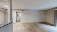 Located at 5000 S Lincoln Trace Ave SE in Smyrna, GA, this one-bedroom, one-bathroom unit offers a practical and well-appointed layout across a single floor. Light hardwood-style flooring runs throughout the space, lending a clean, cohesive aesthetic to every room.

The combined kitchen and living area serves as the heart of the unit. The galley-style kitchen is equipped with stainless steel appliances, including a range and refrigerator, complemented by granite countertops, white shaker cabinetry, and a classic white subway tile backsplash. A skylight provides additional natural light overhead. The adjacent living area is open and airy, with neutral walls and a sliding glass door that leads to a private balcony overlooking a lush, wooded outdoor setting.

The bedroom is a comfortable, well-proportioned space featuring a ceiling fan with light fixture, a window that brings in natural light, and textured ceilings. A dedicated closet provides ample storage. The hallway connects the main living areas to the bedroom and bathroom efficiently.

The bathroom features granite countertop vanity, a full tub-shower combination with clean white tile surround, and wood-style flooring consistent with the rest of the unit. The overall ambiance throughout is bright, neutral, and move-in ready.