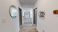 Located at 331 Nisbet St NW in Jacksonville, Alabama, this single-story home offers four bedrooms and four bathrooms across a generously sized floor plan. The interior is finished with a clean, modern aesthetic throughout, featuring light wood-look flooring in the main living and hallway areas and plush carpet in the bedrooms, creating a warm and comfortable feel.

The kitchen is well-appointed with warm wood cabinetry, stainless steel appliances including a refrigerator, dishwasher, and electric range, along with ample counter space. A dedicated dining area and in-unit laundry are conveniently located just off the kitchen.

The hallways are bright and welcoming, with white walls, decorative accents, and easy access to all four bedrooms. Each bedroom is carpeted and offers comfortable proportions, with select rooms featuring built-in desks and shelving — ideal for study or work. The primary bedroom provides a generous footprint with room for a full furniture arrangement. Closets are accessible in multiple bedrooms, offering practical storage solutions.

All four bathrooms feature stone-tile flooring, white fixtures, and tub-shower combinations, maintaining a consistent and clean design throughout. The overall ambiance of the home is bright, neutral, and move-in ready.