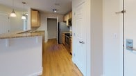 Located at 109 Hopkins St in Reading, Massachusetts, this well-appointed single-floor residence offers a clean, modern aesthetic throughout. The open living area is anchored by warm hardwood-style flooring that extends seamlessly through the space, complemented by recessed lighting and crisp white walls that enhance the bright, airy atmosphere. A sliding glass door leads to an outdoor balcony, inviting natural light and providing views of the surrounding tree-lined landscape.

The kitchen is thoughtfully designed with light maple cabinetry, granite-style countertops, and a full suite of stainless steel appliances including a refrigerator, electric range, and built-in microwave. The layout allows for efficient use of space while maintaining a functional flow to the adjacent living area.

The bedrooms are generously sized, each featuring hardwood-style flooring and large windows that frame natural outdoor views, filling the rooms with abundant daylight. The neutral color palette throughout creates a calm and versatile backdrop.

Two full bathrooms serve the unit, each finished with tile flooring and tub-shower combinations. One bathroom includes a wood-toned vanity with a well-lit mirror, while the other offers a clean, minimalist design. The overall layout, visible in the dollhouse view, reflects a practical and comfortable floor plan well-suited for everyday living.