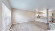 Located at 1712 Midtown Cir in Royal Oak, MI, this three-bedroom, three-bathroom home spans three floors, offering a well-organized layout with consistent modern finishes throughout. The main living level features an open-concept kitchen and living area with light wood-look flooring. The kitchen is outfitted with white shaker cabinetry, granite countertops, stainless steel appliances including a range, microwave, and dishwasher, and a peninsula that connects seamlessly to the living space. Natural light flows in through multiple windows. The entry level includes a staircase with white-painted newel posts and carpeted treads leading to the upper floor. The three bedrooms are carpeted and feature neutral walls and windows providing natural light, including views of surrounding greenery. The primary bedroom offers a comfortable footprint with its own dedicated space. The bathrooms are finished with granite-topped white vanities and wood-look tile flooring; one features a tub-shower combo and another a standalone walk-in shower with built-in shelving. The unfinished basement presents an open, flexible space with exposed mechanicals, concrete flooring, and stair access, offering significant potential for future finishing or storage use.
