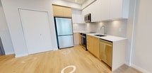 This contemporary 670 square foot apartment in Richmond offers a well-designed living space with two bedrooms and one bathroom. The open-concept layout maximizes the use of space, creating a seamless flow between the living areas. Large windows in the bedrooms and living room flood the space with natural light and provide scenic views of the surrounding area.

The kitchen is a standout feature, boasting sleek cabinetry in a two-tone design of light wood and white. Stainless steel appliances, including a refrigerator, oven, and dishwasher, add a modern touch. The countertops appear to be quartz or a similar high-quality material, offering both style and durability.

The bathroom is elegantly appointed with marble-look tiles, a floating vanity, and a combination tub-shower. The bedrooms, while compact, offer ample space for essential furniture and storage. The primary bedroom measures 140 square feet, providing a comfortable retreat.

Throughout the apartment, light-colored wood flooring creates a warm and inviting atmosphere while also visually expanding the space. The neutral color palette of whites and light tones contributes to the apartment's fresh and airy feel. Recessed lighting in the kitchen and bathroom adds to the modern aesthetic.

This single-floor apartment, located at 507-3600 Sexsmith Road in Richmond, offers a perfect blend of style and functionality, ideal for those seeking a contemporary living space in an urban setting.
