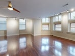 Located at 1800 Fifth Ave in Pittsburgh's vibrant Fifth Avenue corridor, this well-appointed 2-bedroom, 2-bathroom single-floor residence offers a generous and thoughtfully designed layout. Rich, polished hardwood floors flow throughout the main living areas, reflecting natural light that pours in through multiple large windows with classic detailing. The expansive open-concept living, dining, and kitchen area serves as the heart of the home, anchored by a kitchen featuring a granite-topped peninsula with pendant lighting, warm wood cabinetry, stainless steel appliances, and a built-in sink — ideal for both everyday living and entertaining. Track lighting accents the living space, complemented by a ceiling fan for year-round comfort. A hallway connects the living areas to two carpeted bedrooms, each offering a calm retreat. The generously sized primary bedroom includes a dedicated closet and direct access to a bathroom, while the second bedroom also features carpet, a closet, and a sidelight window. Both bathrooms are clean and functional, with one featuring a dark vanity with a glass countertop and a full tub/shower combo with tile flooring. Additional storage is provided by two closets and a utility room, rounding out this well-organized and comfortable Pittsburgh residence.