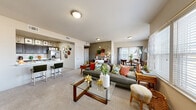 Located at 2400 Watermark Blvd in Oklahoma City, Oklahoma, this single-story, three-bedroom, two-bathroom residence offers a well-designed open-concept layout. The living and dining areas flow seamlessly together, featuring plush carpeting, neutral-toned walls, and large windows that invite abundant natural light and outdoor views. The living room provides a comfortable, spacious feel, while the adjacent dining area is brightened by a generous window arrangement framed by sheer curtains.

The kitchen is outfitted with dark cabinetry, light marble-style countertops, stainless steel appliances including a French door refrigerator, and wood-look tile flooring, creating a clean, modern aesthetic. A breakfast bar connects the kitchen to the living area for added convenience.

The primary bedroom is a well-proportioned retreat featuring carpet flooring, a ceiling fan, and a walk-in closet. The additional bedrooms are similarly appointed with carpet and ceiling fans, offering comfortable, functional spaces. Four closets throughout the unit provide ample storage.

The bathrooms feature wood-look tile flooring, dark vanity cabinetry with white countertops, large mirrors, and a tub-shower combination. Throughout the residence, the consistent use of neutral tones, natural light, and cohesive finishes creates a warm and inviting ambiance.