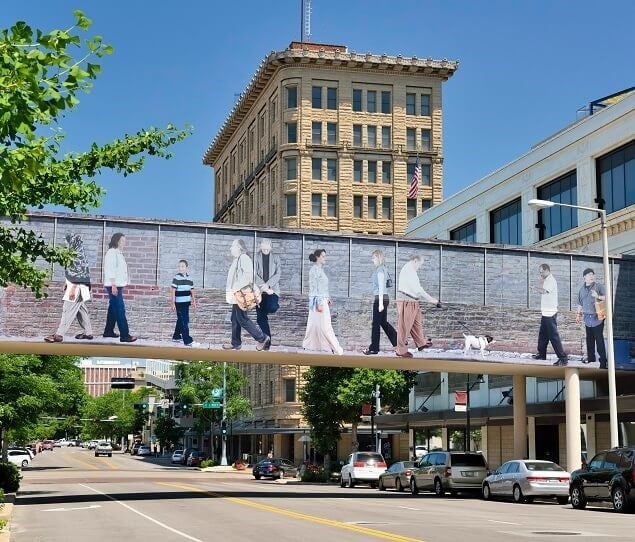 Downtown’s 12th Street skywalk mural was designed by local artist Larry Roots