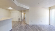 This single-story, 3-bedroom, 2-bathroom home offers a practical and comfortable layout designed for everyday living. The open-concept kitchen and living area serve as the heart of the home, featuring light wood-look vinyl flooring, a peninsula-style breakfast bar, white cabinetry with warm wood accents, and white appliances including a refrigerator and electric range with overhead ventilation. A textured ceiling and recessed lighting complete the space.

The three bedrooms are carpeted and bathed in natural light through windows dressed with vertical blinds. The spacious primary bedroom includes a generously sized walk-in closet outfitted with wire shelving and hanging rods on multiple levels, offering ample storage. The secondary bedrooms each feature sliding-door closets with built-in shelving.

Both bathrooms are finished with wood-look vinyl flooring and include a single vanity with a wide mirror, under-sink cabinet storage, and a full tub/shower combination. The textured walls and clean white fixtures give each bathroom a bright, functional feel.

A dedicated laundry area houses an in-unit dryer, adding everyday convenience. The neutral color palette, consistent flooring, and thoughtful storage solutions throughout make this home a well-organized and move-in-ready space.