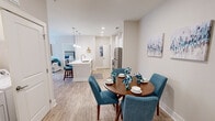 Located in Farragut, Tennessee, this well-appointed 2-bedroom, 2-bathroom single-floor residence offers a thoughtfully designed layout with modern finishes throughout. The open-concept living area features light wood-style flooring, a ceiling fan, and a glass-paned exterior door that fills the space with natural light and provides outdoor access. Adjacent to the living room, a dedicated dining area offers a cozy nook with louvered closet access nearby. The kitchen is a standout, showcasing white shaker-style cabinetry, a large island with a single-basin sink and pendant lighting overhead, stainless steel appliances including a refrigerator, range, and microwave, and a pantry for additional storage. The primary bedroom is generously sized, featuring plush carpet, a ceiling fan, and a bright window with blinds and curtains. The en-suite bathroom includes a glass-enclosed shower and a vanity with white cabinetry. The second bedroom is equally comfortable with carpet, natural light, and ceiling fan. The second bathroom features a full tub-shower combo with subway tile surround. Two closets provide ample storage throughout this clean, modern home.