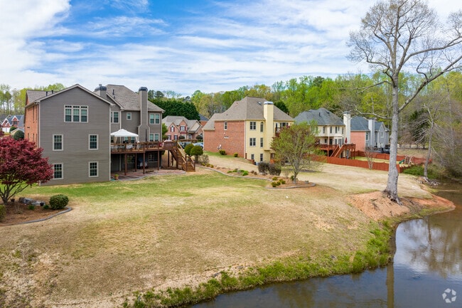 Larger modern homes sit along side a small lake in this newer subdivision in Mableton.