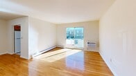 Located at 22 Koster Blvd in Edison, NJ, this one-bedroom, one-bathroom residence offers a well-organized layout across a single floor. Warm hardwood flooring runs throughout, lending a cohesive and inviting feel to the entire space. The combined living and dining area is generously proportioned, bathed in natural light that streams through a sliding glass door opening directly onto a private balcony — ideal for outdoor relaxation and views of the surrounding area. A wall-mounted air conditioning unit and baseboard heating ensure year-round comfort. The kitchen features warm wood cabinetry, white countertops, and a window that keeps the space bright and functional. The bedroom is a comfortable size, highlighted by dual closets and a bright window that fills the room with daylight. With a total of four closets throughout the unit, storage is a notable strength of this floor plan. The full bathroom includes a tiled tub-shower combination and a window for natural ventilation. Clean white walls and crisp trim throughout give the space a neutral, move-in-ready aesthetic. This residence offers practical, comfortable living in a convenient Edison location.