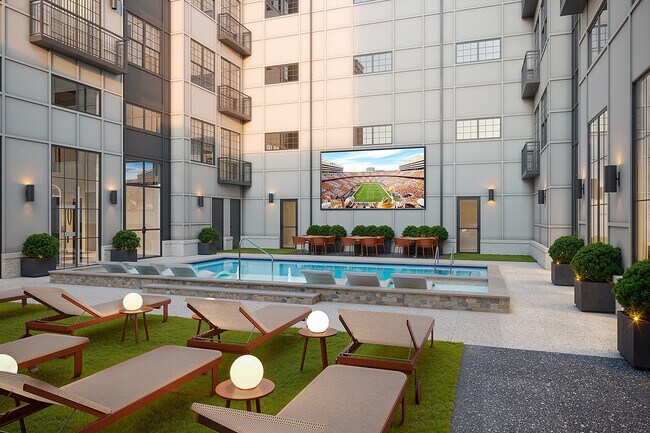 Patio con piscina estilo resort, un rasgo distintivo de los Grand Apartments cerca de UTK. - Signature on Grand