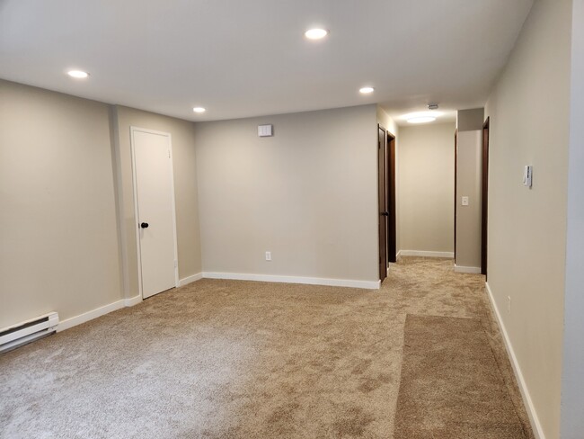Large living room with new lighting, paint and carpet throught unit - 7915 236th St SW