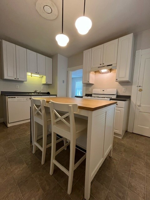 Kitchen with school house pendants and center island with seating for 2 - 46 Fairview St