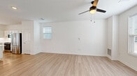 Located at 2010 Deciduous Dr in Grand Rapids, Michigan, this two-story home offers a clean, modern aesthetic spread across two well-proportioned floors. The main level features a bright, open-concept living room with light hardwood-style flooring, a ceiling fan, and natural light from multiple windows. The kitchen is a standout, boasting white shaker cabinetry, a subway tile backsplash, stainless steel appliances, pendant lighting over a central island, and direct access to the exterior. A half bathroom with a pedestal sink and a framed mirror completes the first floor. The staircase connects to the upper level, where three carpeted bedrooms each feature ceiling fans and windows that invite natural light. The spacious primary bedroom provides a comfortable retreat, while the additional bedrooms offer flexibility for guests or a home office. The upper floor also includes a dedicated laundry room equipped with a washer and dryer, adding everyday convenience. With three full bathrooms distributed across both levels, this home balances practicality and style throughout. The consistent use of light tones, clean finishes, and thoughtful layout creates a bright, welcoming atmosphere from every angle.