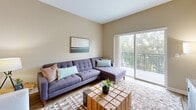 Located at 2448 Winnetka Avenue North in Golden Valley, MN, this one-bedroom, one-bathroom residence offers a well-designed layout that maximizes every square foot. The open-concept kitchen and living area forms the heart of the home, where crisp white shaker cabinetry, granite countertops, and stainless steel appliances — including a refrigerator, range, and microwave — create a polished, functional kitchen. A granite-topped island with bar seating and elegant pendant lighting adds both style and convenience. Light wood-tone flooring flows seamlessly throughout the main living area, enhancing the bright, airy atmosphere. The living room is generously proportioned, featuring a large sliding glass door that opens to a private balcony with tree-lined views, allowing abundant natural light to fill the space. The bedroom offers plush carpeting, a sizable window with outdoor views, and access to a dedicated closet. The full bathroom is finished with a granite vanity, white cabinetry, a tub-shower combination, and tile flooring. Additional features include a utility room, extra closet storage, and a warm, neutral color palette throughout that lends the space a calm, cohesive ambiance suitable for everyday living.