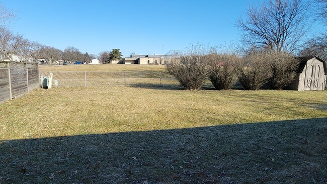 Backyard with view of elementary school and field - 456 W Briarcliff Rd