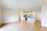 Located at 10203 Karsten Blvd in Rosharon, TX, this single-story, 2-bedroom, 2-bathroom home offers a clean, modern aesthetic throughout. Light-toned hardwood-style flooring flows continuously across the entire space, complementing the crisp white walls and creating a bright, cohesive feel.

The open-concept living, dining, and kitchen area forms the heart of the home. The kitchen is outfitted with white shaker cabinetry, granite countertops, a tiled backsplash, stainless steel appliances including a French door refrigerator and gas range, and a central island with a sink — ideal for both cooking and entertaining. The living area extends to a sliding glass door that opens onto a private, fenced backyard with views of the community's open green space and amenity center.

Both bedrooms are well-sized, each featuring ceiling fans and windows that bring in natural light. The primary bedroom includes a spacious walk-in closet with wire shelving. The bathrooms are finished with granite vanity countertops, white cabinetry, large mirrors, and marble-style tiled tub-shower surrounds. Additional highlights include a dedicated laundry area, a pantry, six closets for ample storage, and hallways connecting the layout efficiently throughout.