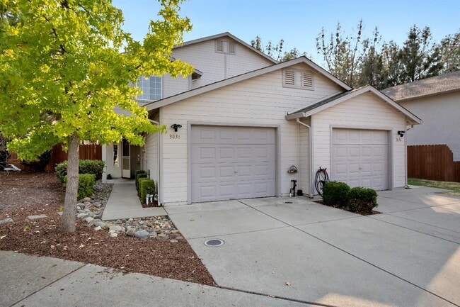 A view of the front of the home & driveway during midday. - 3038 Courtside Dr