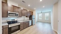 This one-bedroom, one-bathroom apartment at 4824 Walmsley Blvd in Richmond, Virginia offers a thoughtfully designed layout with modern finishes throughout. Light wood-tone flooring flows seamlessly across the entire unit, creating a warm and cohesive aesthetic.

The open living area is bright and welcoming, featuring recessed lighting, neutral walls, and a closet for additional storage. The adjacent kitchen is well-equipped with rich dark-toned cabinetry, granite-look countertops, and a full suite of stainless steel appliances including a range, over-the-range microwave, and dishwasher — ideal for everyday cooking.

The bedroom is a comfortable, light-filled retreat with two windows fitted with blinds that offer views of surrounding greenery, allowing for ample natural light throughout the day.

The bathroom continues the refined design language with dark wood cabinetry, a granite-top vanity with brushed nickel fixtures, and light wood-look flooring. A dedicated closet provides convenient storage directly accessible from the bedroom and bathroom area.

Clean lines, consistent finishes, and a neutral color palette give this apartment a modern, move-in-ready feel throughout.