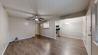 Located at 1330 E 48th Pl in Tulsa, Oklahoma, this single-story, one-bedroom, one-bathroom home offers a thoughtfully arranged layout that maximizes every square foot. The open living area greets you at the entry, featuring rich, dark hardwood-style flooring, neutral gray walls, and a ceiling fan that anchors the space. Natural light filters in through windows with views of surrounding greenery, creating a warm and inviting atmosphere.

The living area flows seamlessly into the dining and kitchen zones. The kitchen is well-appointed with white shaker-style cabinetry, granite countertops, a classic subway tile backsplash, and a full suite of stainless steel appliances including a refrigerator, range, and microwave. A pass-through window connects the kitchen to the living and dining area, enhancing the open feel.

The bedroom is a comfortable retreat finished with plush carpeting, a ceiling fan, and a window offering natural light and outdoor views. It includes access to a dedicated closet and conveniently houses an in-unit washer and dryer. The bathroom features wood-style flooring, a granite-topped vanity, and a tiled tub-shower combination with a decorative mosaic accent border and a window for natural ventilation. A hallway connects the private areas of the home efficiently.