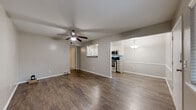 Located at 1330 E 48th Pl in Tulsa, Oklahoma, this single-story, one-bedroom, one-bathroom home offers a thoughtfully arranged layout that maximizes every square foot. The open living area greets you at the entry, featuring rich, dark hardwood-style flooring, neutral gray walls, and a ceiling fan that anchors the space. Natural light filters in through windows with views of surrounding greenery, creating a warm and inviting atmosphere.

The living area flows seamlessly into the dining and kitchen zones. The kitchen is well-appointed with white shaker-style cabinetry, granite countertops, a classic subway tile backsplash, and a full suite of stainless steel appliances including a refrigerator, range, and microwave. A pass-through window connects the kitchen to the living and dining area, enhancing the open feel.

The bedroom is a comfortable retreat finished with plush carpeting, a ceiling fan, and a window offering natural light and outdoor views. It includes access to a dedicated closet and conveniently houses an in-unit washer and dryer. The bathroom features wood-style flooring, a granite-topped vanity, and a tiled tub-shower combination with a decorative mosaic accent border and a window for natural ventilation. A hallway connects the private areas of the home efficiently.