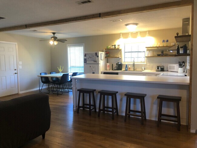 Kitchen view from couches-table, chairs, bar stools, and kitchenware included - 130 Richard Dr