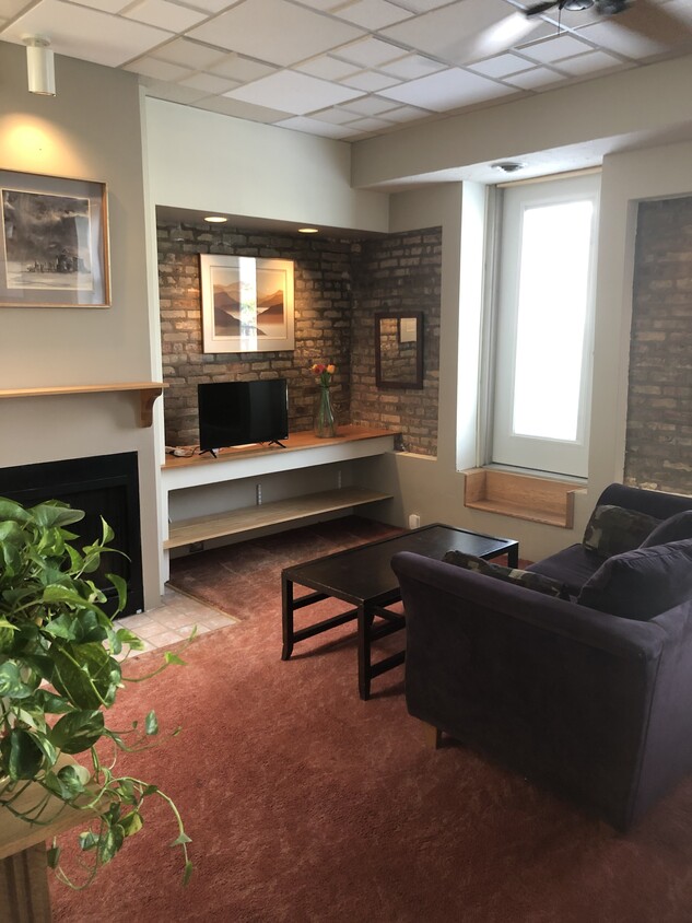 Exposed brick, fireplace, built-in shelving - 3313 N Clark St