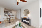 Located at 101 Crawford St in the heart of Houston, TX, this single-story residence offers a thoughtfully designed open-concept layout encompassing one bedroom, two bathrooms, a dedicated office, and generous storage throughout. Light wood-look flooring flows through the main living areas, complemented by clean white walls and recessed lighting that create a bright, airy ambiance.

The welcoming entrance opens into a seamless living and dining area, where a ceiling fan overhead and large windows allow natural light to pour in. The kitchen is outfitted with rich dark cabinetry, stainless steel appliances including a full-size refrigerator, a stylish herringbone tile backsplash, and a peninsula with pendant lighting and a built-in wine cooler — ideal for entertaining.

The spacious primary bedroom features multiple windows framing outdoor greenery, plush carpeting, and a ceiling fan, lending a calm and restful atmosphere. It is accompanied by a generous walk-in closet with full shelving and hanging systems. The bathrooms are finished with clean white subway tile, including a soaking tub-shower combination.

A separate office provides a quiet workspace, while the dedicated laundry room and five total closets ensure exceptional storage. This residence combines modern finishes with functional design in a prime downtown Houston location.
