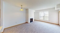 Located at 993 Robert St S in West St. Paul, Minnesota, this single-floor unit offers a practical and comfortable layout with well-defined living spaces throughout. The open-concept living and dining area is anchored by a fireplace and flows seamlessly into the kitchen, which is equipped with warm honey-toned wood cabinetry, stainless steel appliances including a refrigerator, range, microwave, and dishwasher, and a central island with a light countertop surface. Track lighting overhead and tile flooring complete the kitchen's functional design. The living area features plush carpeting, warm wood baseboards, and a large window that brings in natural light and outdoor views. The bedrooms are generously sized, each with soft carpeting, ample natural light from multiple windows, and neutral walls that offer a clean, versatile canvas. The two bathrooms are finished with tile surrounds around the soaking tubs, a separate glass-enclosed shower in one bathroom, wood vanity cabinetry, and light flooring. One bathroom includes a window with a view of surrounding greenery, adding a touch of natural ambiance. The overall aesthetic is clean, neutral, and move-in ready, making it a practical and inviting space.