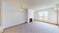 Located at 993 Robert St S in West St. Paul, Minnesota, this single-floor unit offers a practical and comfortable layout with well-defined living spaces throughout. The open-concept living and dining area is anchored by a fireplace and flows seamlessly into the kitchen, which is equipped with warm honey-toned wood cabinetry, stainless steel appliances including a refrigerator, range, microwave, and dishwasher, and a central island with a light countertop surface. Track lighting overhead and tile flooring complete the kitchen's functional design. The living area features plush carpeting, warm wood baseboards, and a large window that brings in natural light and outdoor views. The bedrooms are generously sized, each with soft carpeting, ample natural light from multiple windows, and neutral walls that offer a clean, versatile canvas. The two bathrooms are finished with tile surrounds around the soaking tubs, a separate glass-enclosed shower in one bathroom, wood vanity cabinetry, and light flooring. One bathroom includes a window with a view of surrounding greenery, adding a touch of natural ambiance. The overall aesthetic is clean, neutral, and move-in ready, making it a practical and inviting space.
