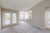 Located at 701 T C Jester Blvd in Houston's desirable 77008 corridor, this two-bedroom, two-bathroom single-floor residence offers a well-designed layout with a comfortable, functional flow throughout. The open living and dining area is anchored by plush carpeting, vaulted ceilings, and abundant natural light streaming through large windows and a glass-paneled exterior door that leads to a private outdoor area. A pass-through kitchen overlooks the living space and features sleek white cabinetry, granite stone countertops, a tile backsplash, stainless steel appliances including a refrigerator and range, and wood-look flooring for easy maintenance. Pendant lighting above the breakfast bar adds a warm, inviting touch. Both bedrooms are generously proportioned, carpeted for comfort, and equipped with ceiling fans and ample closet space. The primary bedroom offers a spacious layout with plenty of room to furnish. The bathrooms are finished with granite vanities, white cabinetry, and full tub-shower combinations with clean tile surrounds. A dedicated in-unit laundry room with side-by-side washer and dryer connections adds everyday convenience. Neutral tones and clean finishes throughout create a bright, move-in-ready atmosphere.