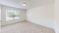 Located at 2945 Rosebud Rd in Loganville, GA, this 2-bedroom, 2-bathroom unit delivers a practical and comfortable single-floor layout. The kitchen features white cabinetry with ample upper and lower storage, light granite-style countertops, a coil-burner range, and wood-look plank flooring that extends into the adjoining areas. Both bedrooms are carpeted and finished in neutral tones, with the primary bedroom offering a generous footprint and direct access to its own private bathroom. Each bathroom is appointed with a tiled tub-shower combination, wood-look plank flooring, and clean white fixtures. Both bedrooms are served by their own walk-in closets, each outfitted with multi-tier wire shelving systems that maximize storage capacity. A dedicated laundry room includes washer/dryer hookups and an overhead wire shelf for added utility. Throughout the unit, crisp white walls, flush-mount lighting, and consistent neutral finishes create a clean, cohesive aesthetic. Windows in the bedrooms allow for natural light and views of surrounding greenery, contributing to a bright and welcoming atmosphere across the entire floor plan.