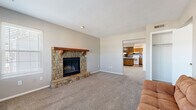 Located at 5804 NE 41st St in Kansas City, Missouri, this single-story, three-bedroom, one-bathroom home offers a functional and comfortable layout. The main living area makes a strong impression with its striking stone fireplace, complete with a wooden mantel and raised hearth, set against neutral walls and soft carpeting. A second living area provides additional flexible space, filled with natural light from multiple windows with blinds and direct access to the entry door.

The kitchen is well-appointed with a U-shaped layout featuring warm wood cabinetry, granite-style countertops, a tiled backsplash, and a peninsula that opens toward the living space. The kitchen is equipped with a white range, refrigerator, and dishwasher, with hardwood-style flooring completing the look.

The three bedrooms are carpeted and offer a calm, neutral palette, each with windows that bring in natural light. The spacious primary bedroom includes built-in shelving and closet space. The bathroom features a granite-topped vanity with a mirror. A connecting hallway ties the rooms together efficiently. Additional storage is available via a pantry-style cabinet in the kitchen area. This home offers a practical and cozy layout suited for everyday living.
