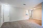 Located at 777 Valleybrook Crossing in Decatur, Georgia, this single-floor residence offers a well-organized layout with a clean, neutral aesthetic throughout. The galley-style kitchen is a standout feature, equipped with white shaker cabinetry, granite-look countertops, a classic subway tile backsplash, a gas range, and black appliances including a refrigerator and dishwasher. Wood-look luxury vinyl flooring runs through the kitchen and connecting areas, providing a cohesive and easy-to-maintain foundation. The living and bedroom areas are finished with plush wall-to-wall carpeting, creating a warm and comfortable atmosphere. Bedrooms are generously sized, offering natural light through blinds-fitted windows, and include sliding or hinged closet doors with built-in shelving and rod storage. The bathroom features a white vanity with granite-look countertops, a framed mirror, and a separate tub/shower combination, all finished with the same wood-look flooring for continuity. Textured ceilings are present throughout, and neutral gray and beige tones on the walls provide a versatile backdrop. The functional floor plan, as illustrated by the 3D dollhouse view, demonstrates a thoughtfully arranged single-level space suited for comfortable everyday living.