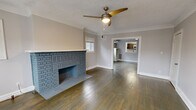 Located at 2878 Mayfield Rd in Cleveland Heights, Ohio, this single-floor, one-bedroom, one-bathroom residence offers a well-organized layout that makes efficient use of its space. The living room serves as the heart of the home, showcasing rich hardwood floors, crown molding, a textured ceiling, and a striking painted brick fireplace as the focal point. Multiple windows flood the room with natural light, while a ceiling fan adds comfort. The space flows directly into the galley-style kitchen, which features dark cabinetry, granite countertops, a white subway tile backsplash, stainless steel appliances including a gas range, microwave, and refrigerator, and light wood-look flooring. A window above the counter brings in additional natural light. The bedroom is a comfortable, carpeted retreat with its own ceiling fan, dual windows, and access to a dedicated closet. A hallway connects the rooms seamlessly to the full bathroom, which includes a shower-tub combination, a white vanity, wood-look flooring, and a privacy window. The layout is practical and cohesive, making this a well-appointed single-level residence in the Cleveland Heights community.