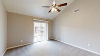 This well-designed 1-bedroom, 1-bathroom residence at 4045 Treadway Rd in Beaumont, Texas offers an efficient and comfortable layout across a single floor. The open-concept living and dining area is immediately welcoming, highlighted by soaring vaulted ceilings and ceiling fans that enhance the sense of spaciousness and airflow. Soft carpeting runs throughout the living spaces, adding warmth underfoot, while neutral-toned walls provide a clean, versatile backdrop. Sliding glass doors lead to a private balcony, flooding the living area with natural light and offering outdoor access. The kitchen features white cabinetry, dark appliances including a refrigerator and dishwasher, a breakfast bar, and wood-look flooring, with a dedicated pantry nearby for added storage convenience. The generously sized bedroom includes a ceiling fan, a window with natural light, and direct access to a walk-in closet. An additional closet provides further storage. The bathroom is finished with a full tub/shower combo featuring white tile surround and brushed nickel fixtures, complemented by wood-look flooring. Throughout the home, the consistent neutral palette and thoughtful layout create a cohesive and functional living environment.