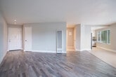 Located at 34500 Fremont Blvd in Fremont, CA, this well-appointed one-bedroom, one-bathroom residence offers a thoughtfully designed single-floor layout with a comfortable and functional use of space. The open-concept living and dining area is a standout feature, showcasing rich hardwood-style flooring, neutral-toned walls, and generous natural light streaming through multiple windows fitted with horizontal blinds. A sliding glass door leads directly to a private balcony, further brightening the living space and providing an outdoor retreat. The kitchen is efficiently designed with crisp white cabinetry, dark countertops, light tile flooring, and a full suite of stainless steel appliances including a refrigerator, gas range, and dishwasher — complemented by a window that brings in additional natural light. The bedroom offers a cozy, well-proportioned retreat with hardwood-style flooring, a large sliding-door closet, and a bright window with outdoor views. Four total closets throughout the unit provide ample storage. Additional spaces include a hallway, a utility room, and a full bathroom. The consistent neutral palette and modern finishes create a clean, cohesive ambiance throughout the entire residence.