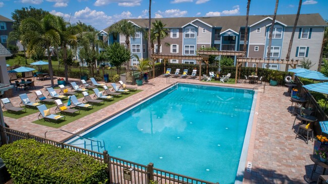 This captivating aerial view showcases our magnificent resort-style swimming pool and its expansive sundeck. Here, everyone has space to stretch out, bask in the sun, and relish the ultimate in outdoor relaxation. - Ashton Chase