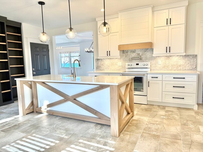 Kitchen, Custom farmhouse island with seating. Black door on left is basement door. - 24 Ash St N