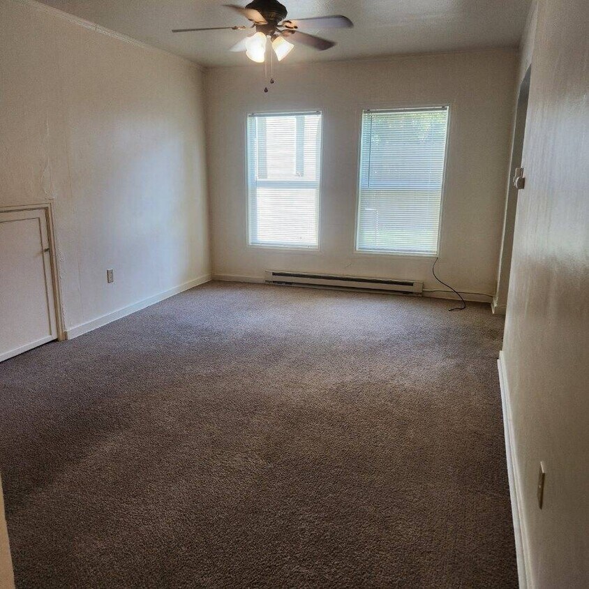 Living area with extra storage under stairs in apartment on wall in photo - 248 E Birch St