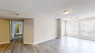 Located at 925 Gresham Ave NE in Marietta, GA, this well-appointed 2-bedroom, 2-bathroom single-floor residence offers a functional and comfortable layout. The open living room is bright and welcoming, featuring wood-look flooring, neutral beige walls, textured ceilings, and large windows that invite generous natural light. A ceiling fan adds comfort to the living area, which flows seamlessly toward the kitchen pass-through.

The galley-style kitchen is efficiently designed with white cabinetry, light countertops, a stainless steel refrigerator, stainless electric range, under-cabinet microwave, and a double sink — all complemented by easy-to-maintain hard surface flooring.

Both bedrooms are carpeted and offer a quiet, restful atmosphere. The primary bedroom is a well-proportioned retreat featuring a ceiling fan, a window with outdoor views, and closet storage with built-in shelving. The secondary bedroom is similarly finished with neutral tones and plush carpeting.

Each of the two bathrooms includes a tub/shower combination with clean white surrounds and chrome fixtures. The overall color palette throughout the home is soft and neutral, creating a cohesive, move-in ready feel across every room.
